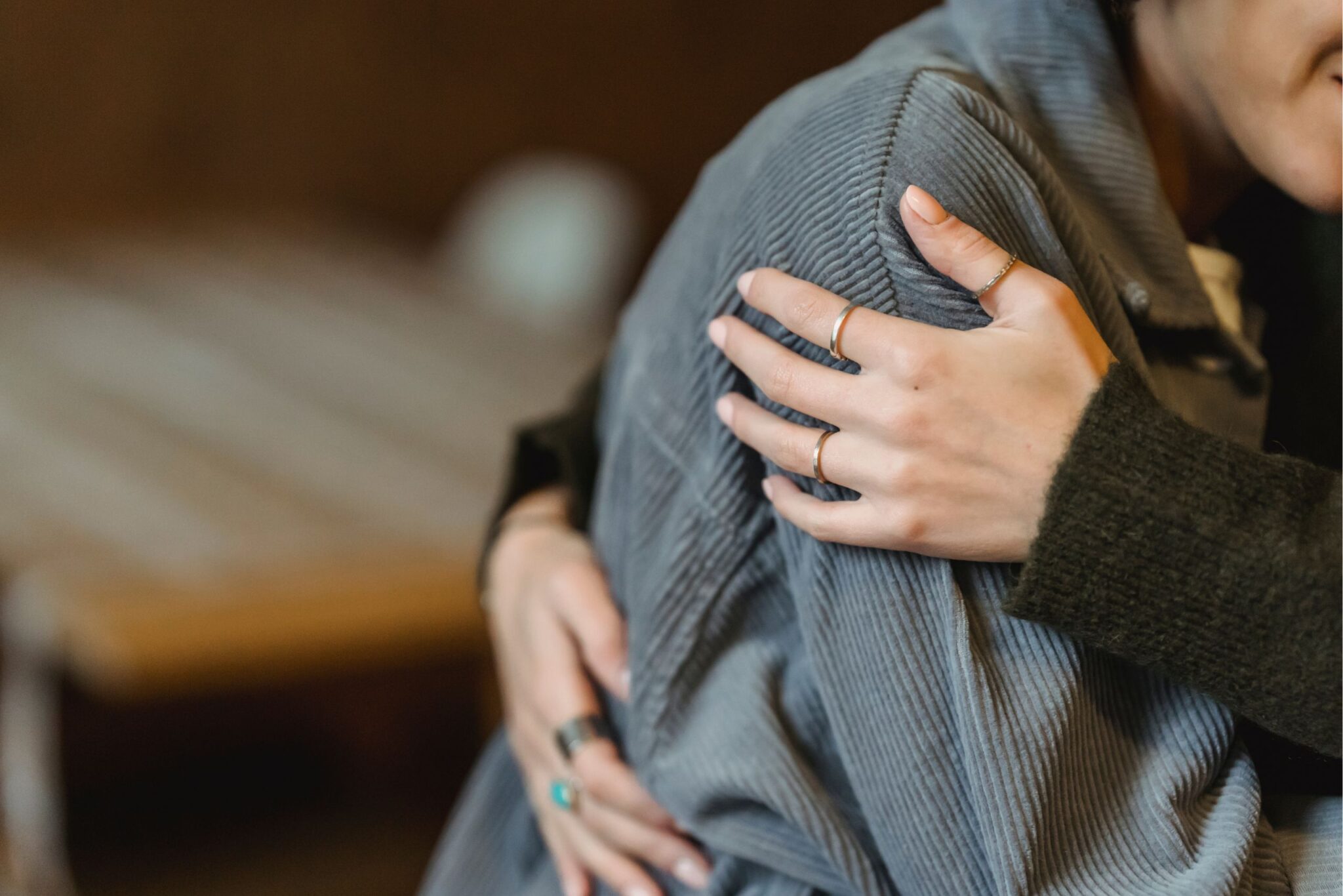 Woman holding onto another woman while she’s entering complicated grief treatment