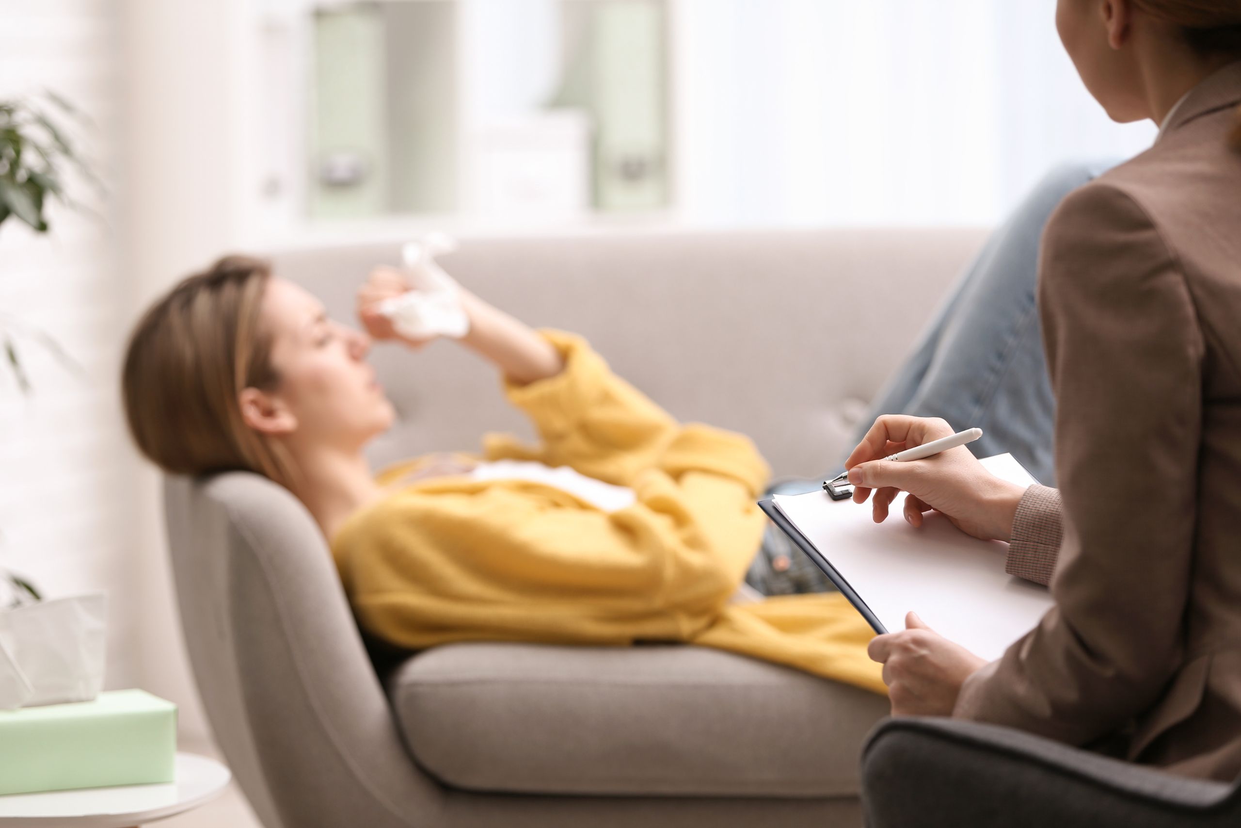 woman laying on a couch speaking to her therapist about Mental Health Statistics in Philadelphia