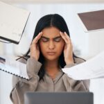 woman sitting at desk working struggling with high functioning depression symptoms