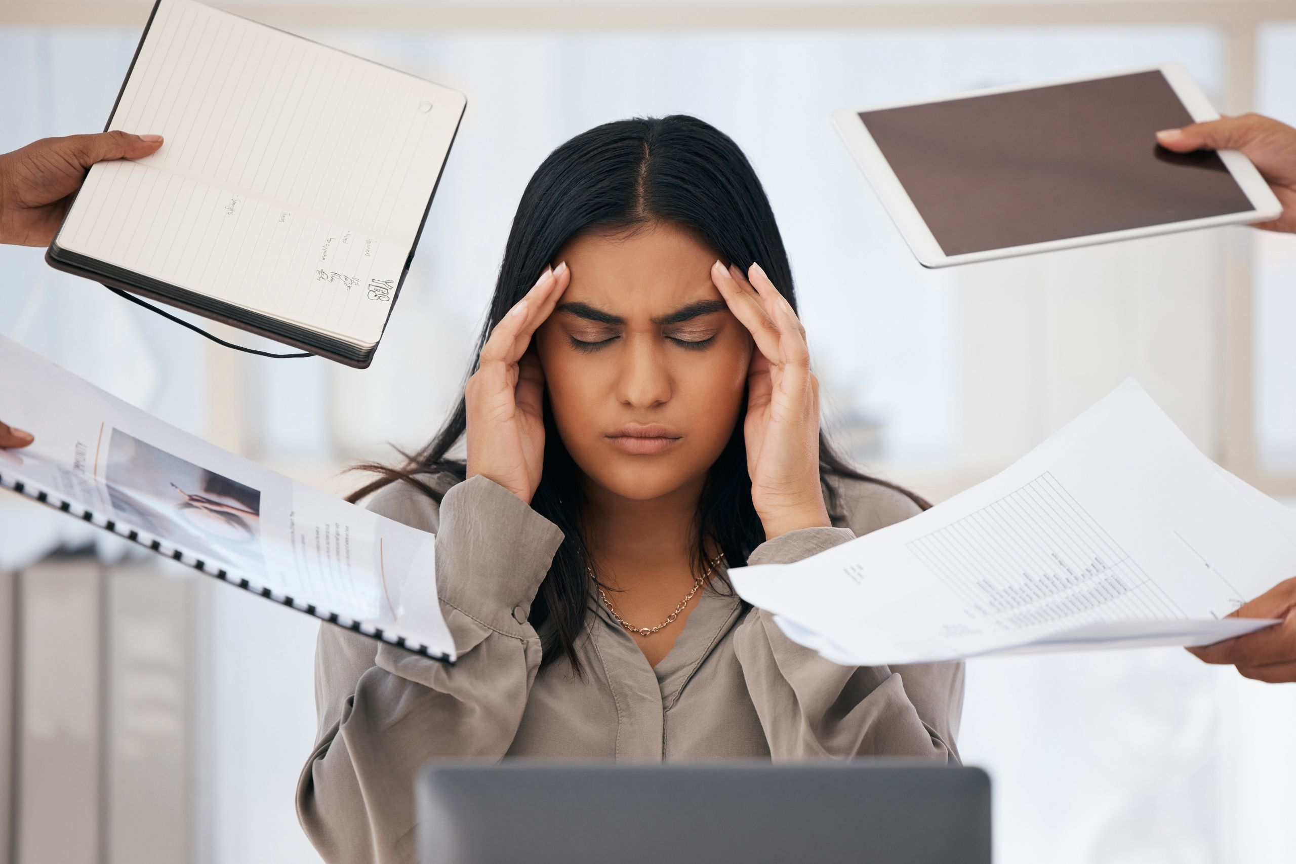 woman sitting at desk working struggling with high functioning depression symptoms