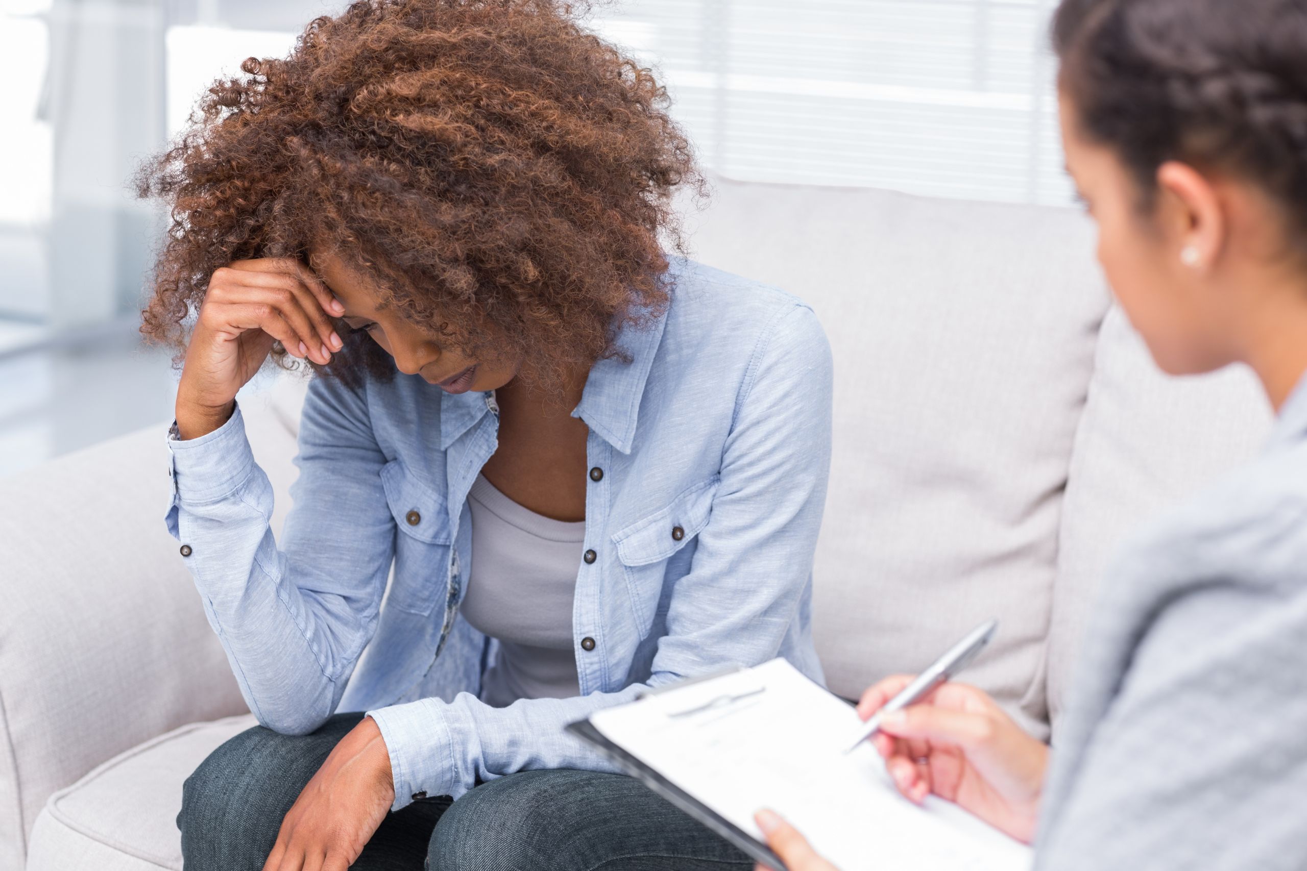 woman sitting on couch speaking with doctor about depression medication