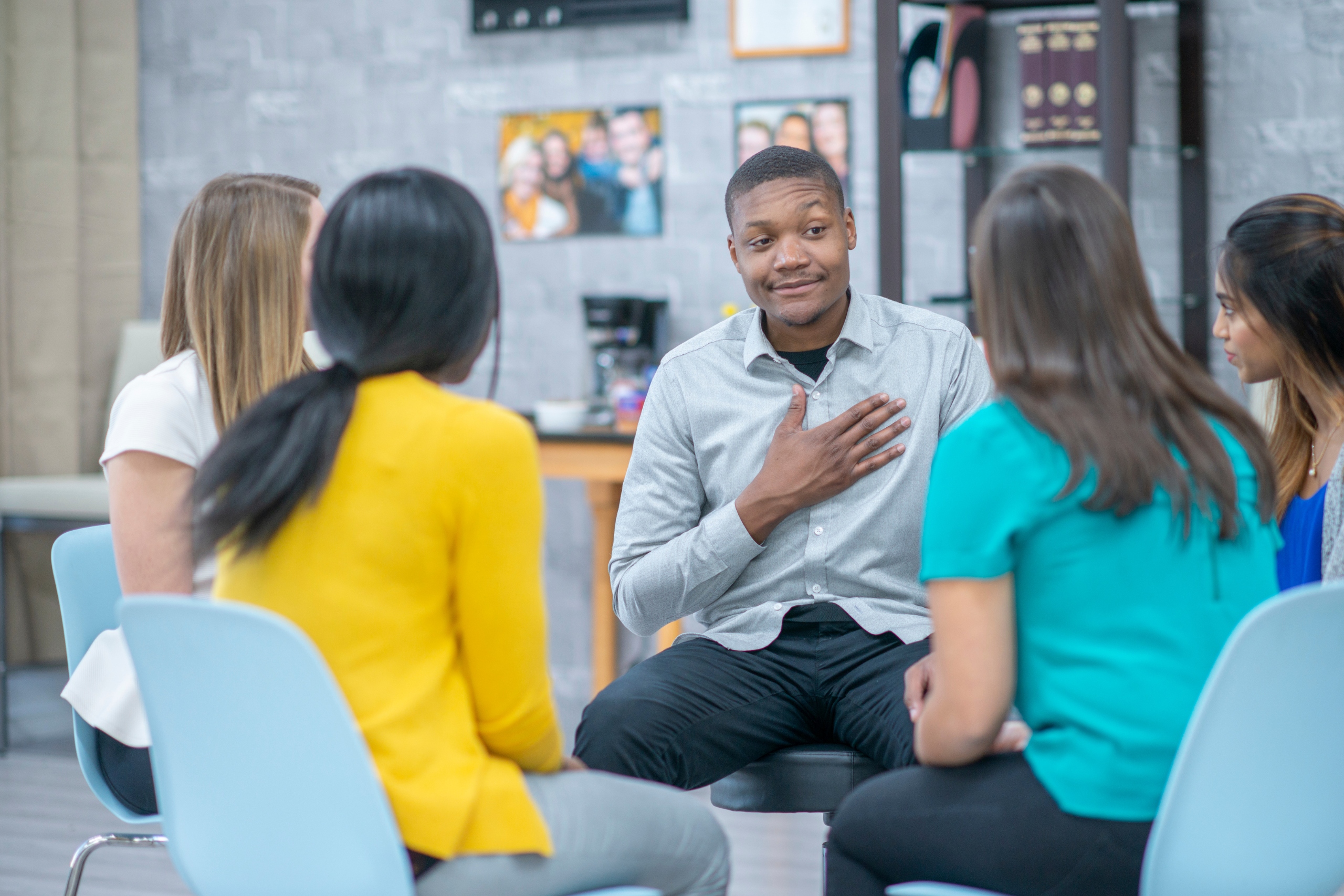 man sitting in group at new mind wellness discussing with other clients what does depression feel like