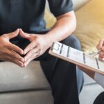 man asking his therapist can you check into a mental hospital for depression