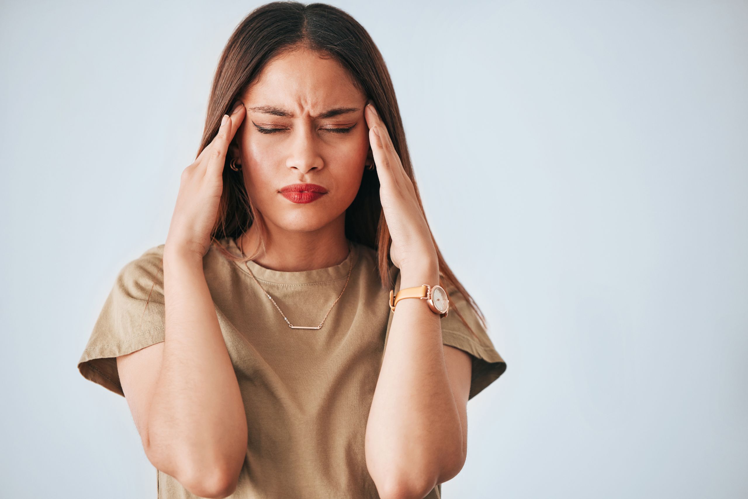 woman holding the temples of her head wishing she knew how to cope with high functioning anxiety