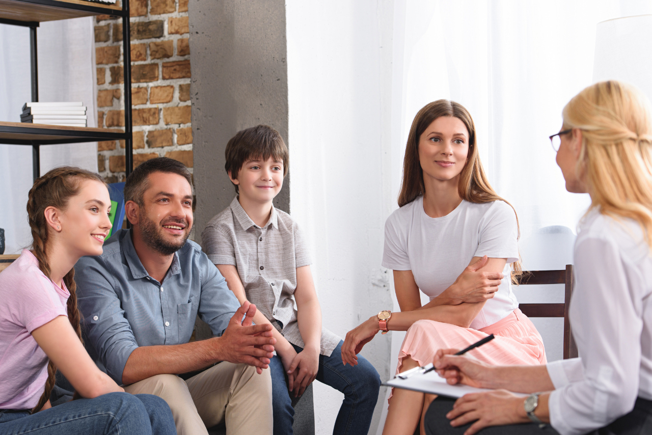 mother and father with their child sitting on the couch speaking to their therapist in Family Therapy in Philadelphia