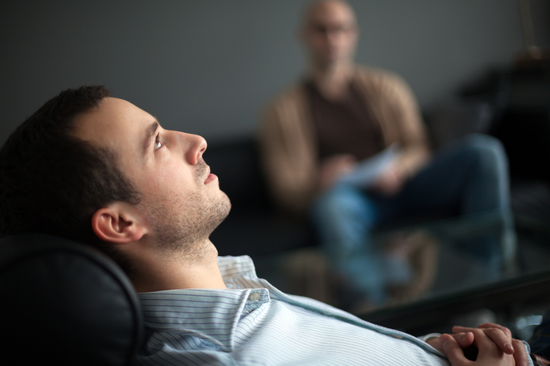 man laying in a couch speaking to his therapist about is ocd a disability