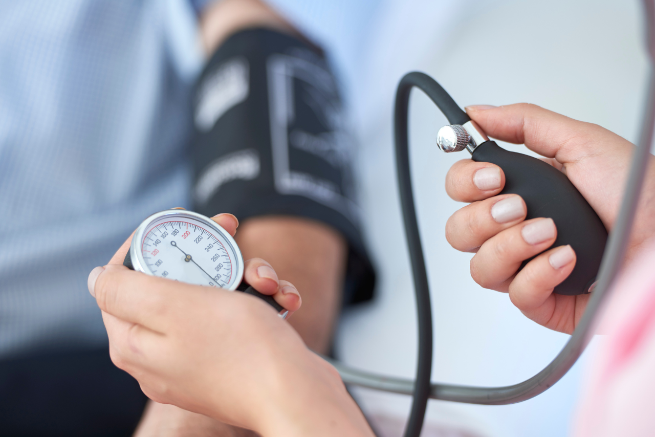 nurse taking a patients blood pressure while he is asking Can Anxiety Cause High Blood Pressure?